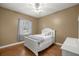 Charming bedroom with hardwood floors and a white bed frame at 5224 Se 44Th Cir, Ocala, FL 34480