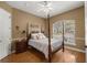 Bedroom with a four-poster bed, wood floors, and window at 5224 Se 44Th Cir, Ocala, FL 34480