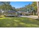 House exterior with lush green lawn and three-car garage at 5224 Se 44Th Cir, Ocala, FL 34480