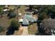 A bird's-eye view of the property with the house, pool, and surrounding greenery at 5491 Sw 100Th Loop, Ocala, FL 34476