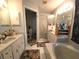 Clean bathroom with double sinks, a bathtub, and a separate shower at 5491 Sw 100Th Loop, Ocala, FL 34476