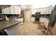 Kitchen with white cabinets, stainless steel appliances, and tile flooring at 5491 Sw 100Th Loop, Ocala, FL 34476