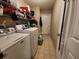 Functional laundry room with washer, dryer, and shelving at 5491 Sw 100Th Loop, Ocala, FL 34476