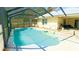 Inviting screened-in pool area, with stairs and a relaxing atmosphere at 5491 Sw 100Th Loop, Ocala, FL 34476