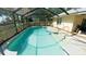 Enjoy this sparkling in-ground pool inside the screened-in pool area at 5491 Sw 100Th Loop, Ocala, FL 34476