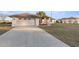 Exterior view of a house with a long driveway at 5525 Sw 80Th Pl, Ocala, FL 34476