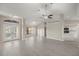 Open living room with gray flooring and high ceilings at 5525 Sw 80Th Pl, Ocala, FL 34476