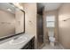 Clean bathroom with dark vanity and shower at 562 Silver Course Loop, Ocala, FL 34472