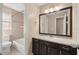 Bathroom with vanity, mirror, and tub shower combo at 562 Silver Course Loop, Ocala, FL 34472