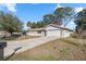 Single story home with attached garage and large yard at 562 Silver Course Loop, Ocala, FL 34472