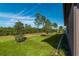 Large backyard with green grass and mature trees at 6758 Sw 94Th Cir, Ocala, FL 34481