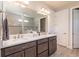 Double vanity bathroom with modern fixtures and a large mirror at 6758 Sw 94Th Cir, Ocala, FL 34481