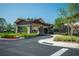 Welcoming clubhouse entrance with a covered porte-cochere and manicured landscaping at 6758 Sw 94Th Cir, Ocala, FL 34481