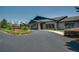 Attractive clubhouse exterior featuring meticulously landscaped grounds and a circular driveway at 6758 Sw 94Th Cir, Ocala, FL 34481
