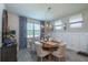 Bright dining room with wood table and blue patterned curtains at 6758 Sw 94Th Cir, Ocala, FL 34481