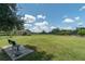 Spacious community dog park with green grass, trees, benches, and shaded areas at 6758 Sw 94Th Cir, Ocala, FL 34481