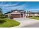 Two-story home with three-car garage and well-manicured lawn at 6758 Sw 94Th Cir, Ocala, FL 34481