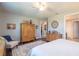 Main bedroom with large bed, a sitting area, and an attached bathroom at 6758 Sw 94Th Cir, Ocala, FL 34481