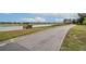 Scenic view of a tranquil pond with a walking path in a picturesque community setting at 6758 Sw 94Th Cir, Ocala, FL 34481