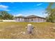 Back of house showing large yard and water tank at 7 Bahia Circle Loop, Ocala, FL 34472