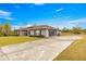 House with a two-car garage and a long driveway at 7 Bahia Circle Loop, Ocala, FL 34472