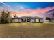 House exterior at sunset, single story with front yard at 7 Bahia Circle Loop, Ocala, FL 34472