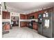 Kitchen with dark wood cabinets, black appliances, and tile floor at 7 Bahia Circle Loop, Ocala, FL 34472