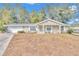 Tan house with white trim, a covered porch, and a spacious yard at 8137 Sw 117Th Loop, Ocala, FL 34481