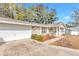 Tan house with white trim, a covered porch, and a spacious yard at 8137 Sw 117Th Loop, Ocala, FL 34481