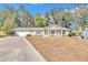 Tan house with white trim, a covered porch, and a spacious yard at 8137 Sw 117Th Loop, Ocala, FL 34481