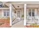 Inviting front porch with rocking chairs and white columns at 8137 Sw 117Th Loop, Ocala, FL 34481