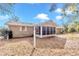 Tan house exterior with screened porch and large backyard at 8137 Sw 117Th Loop, Ocala, FL 34481