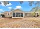 Tan house exterior with screened porch and large backyard at 8137 Sw 117Th Loop, Ocala, FL 34481