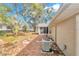 Backyard view of tan house with screened porch and AC unit at 8137 Sw 117Th Loop, Ocala, FL 34481