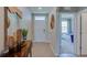 Bright entryway with wood console table and view to bedroom at 8489 Las Palmas Way, Wildwood, FL 34785