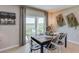 Rustic dining room with a wooden table, white chairs, and sliding glass doors at 8493 Las Palmas Way, Wildwood, FL 34785