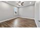 Bright bedroom with wood-look floors and ceiling fan at 9010 Sw 89Th Loop, Ocala, FL 34481