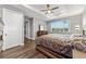 Main bedroom with wood floor, large bed, and window at 9010 Sw 89Th Loop, Ocala, FL 34481