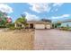 Single-story house featuring a three-car garage and well-manicured landscaping at 9010 Sw 89Th Loop, Ocala, FL 34481