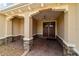 Covered front porch entry with double doors and stone accents at 9010 Sw 89Th Loop, Ocala, FL 34481