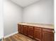 Functional laundry room, granite countertop, wood cabinets at 9010 Sw 89Th Loop, Ocala, FL 34481