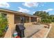 Relaxing screened patio featuring a brick wall, grill, and comfortable lounge chairs at 9010 Sw 89Th Loop, Ocala, FL 34481