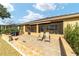 Screened patio with paver stones, comfortable seating, and a built-in grill at 9010 Sw 89Th Loop, Ocala, FL 34481