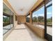 Relaxing screened porch with tile floor, ceiling fan, and views of the backyard at 9010 Sw 89Th Loop, Ocala, FL 34481