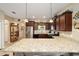 Kitchen features granite island and breakfast bar at 9872 Sw 99Th Loop, Ocala, FL 34481