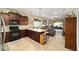 Open kitchen boasts granite countertops and dark wood cabinetry at 9872 Sw 99Th Loop, Ocala, FL 34481