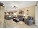 Open living area with gray couches and a view into kitchen at 9872 Sw 99Th Loop, Ocala, FL 34481