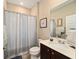 Bathroom with shower/tub combo and dark brown vanity at 9872 Sw 99Th Loop, Ocala, FL 34481