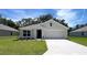 Charming single-story home featuring a well-manicured lawn and a two-car attached garage at 9996 Se 161St Lane Rd, Summerfield, FL 34491