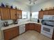 Kitchen with wood cabinets and corner sink at 11105 Sw 69Th Cir, Ocala, FL 34476